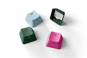 A close up of the various PBT Keycaps in Pine Green, Pastel Blue, and Bright Pink.