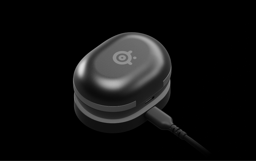 A photo showing the Gamebuds attached to the wireless charging device.