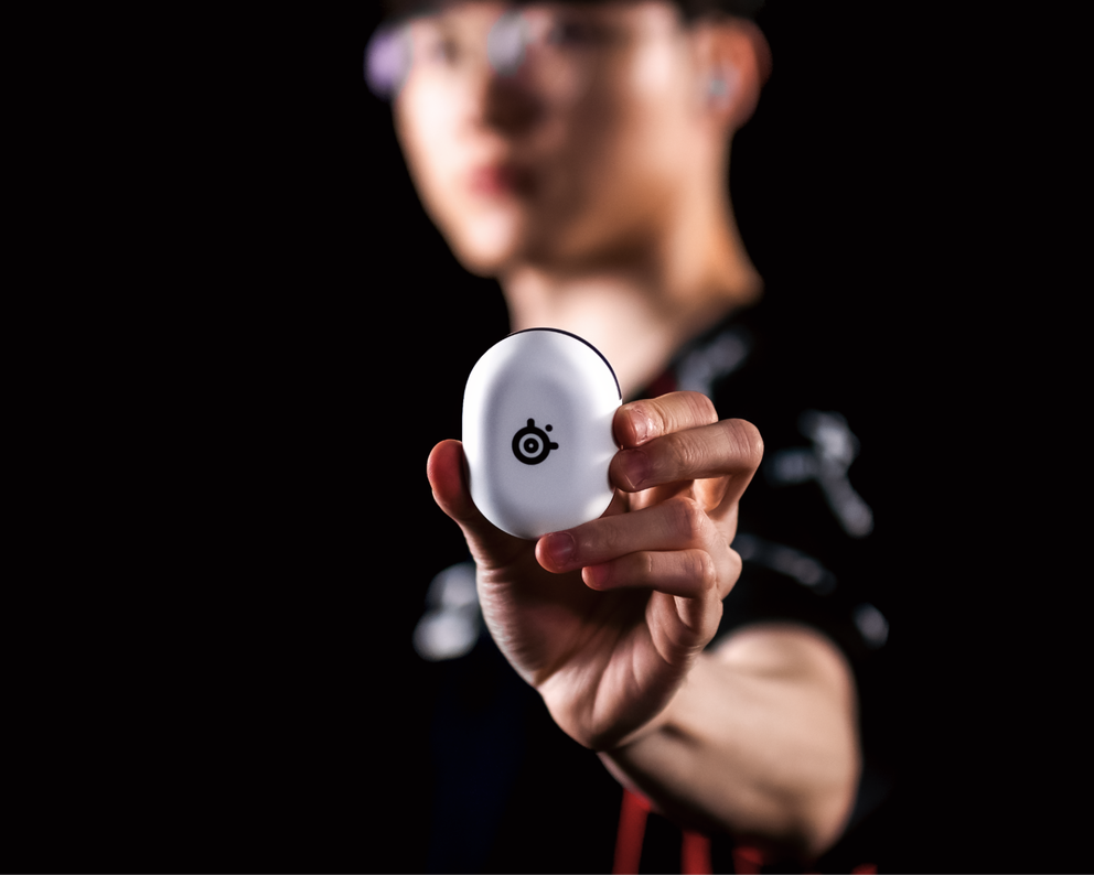 
 A photo of a person holding the GameBuds.
 