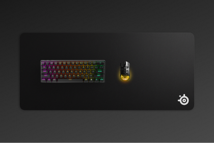 An image of the QcK XXL mousepad with an Apex keyboard and Aerox mouse sitting on top.